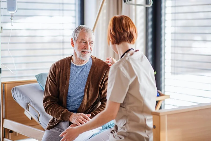 Nurse providing compassionate hospital care to an older adult patient at a rural healthcare facility