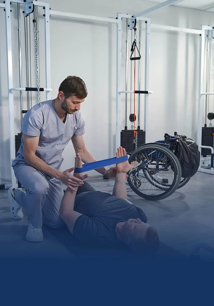 Rehabilitation therapist guiding a patient through resistance band exercises to improve strength and mobility