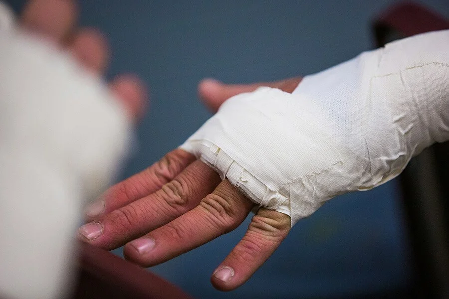Bandaged hand receiving medical treatment, representing wound care services at North Runnels Hospital District.