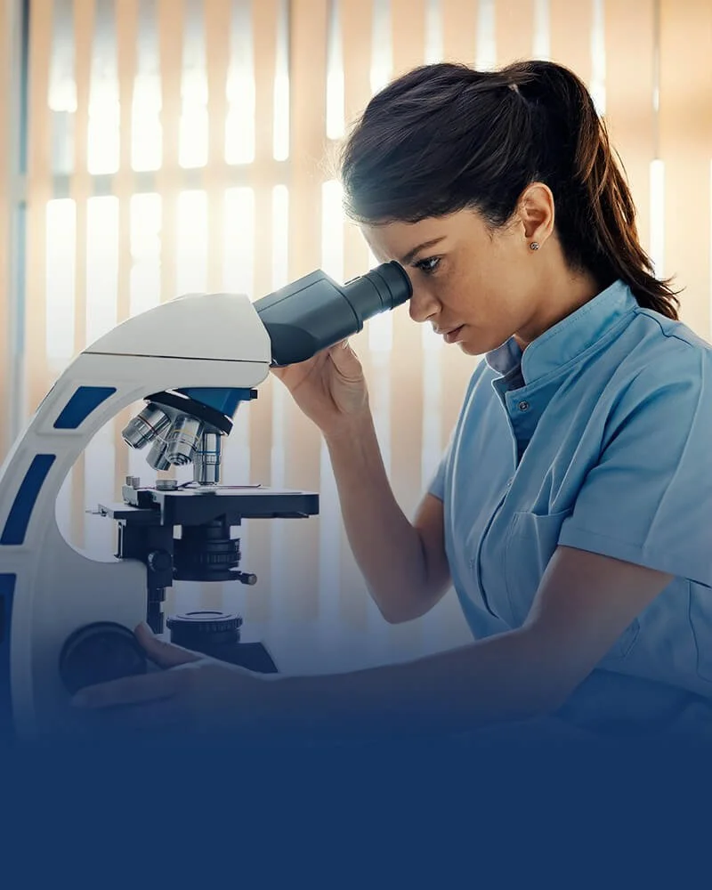 Medical laboratory professional using a microscope for diagnostic testing and laboratory services