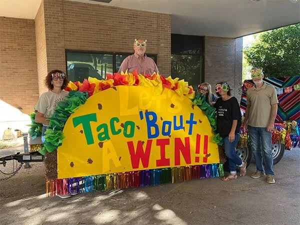North Runnels Hospital District community members gathered around a colorful taco-themed display during a local celebration.