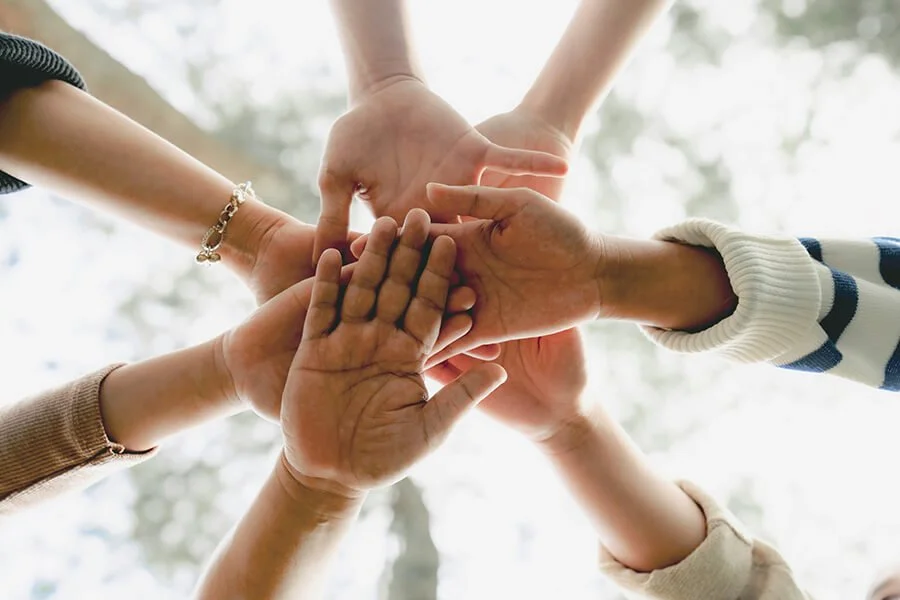 Hands joined together representing teamwork, community support, and North Runnels Hospital District’s commitment to local families.