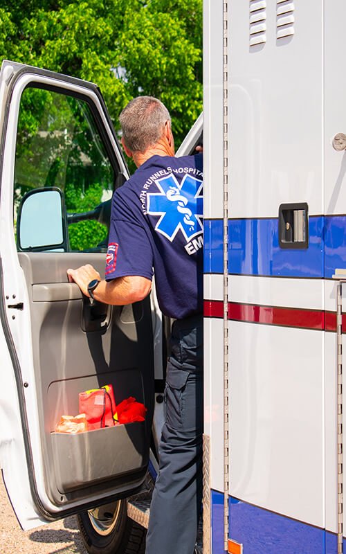 North Runnels Hospital EMS professional preparing an ambulance to provide emergency medical care in the local community.