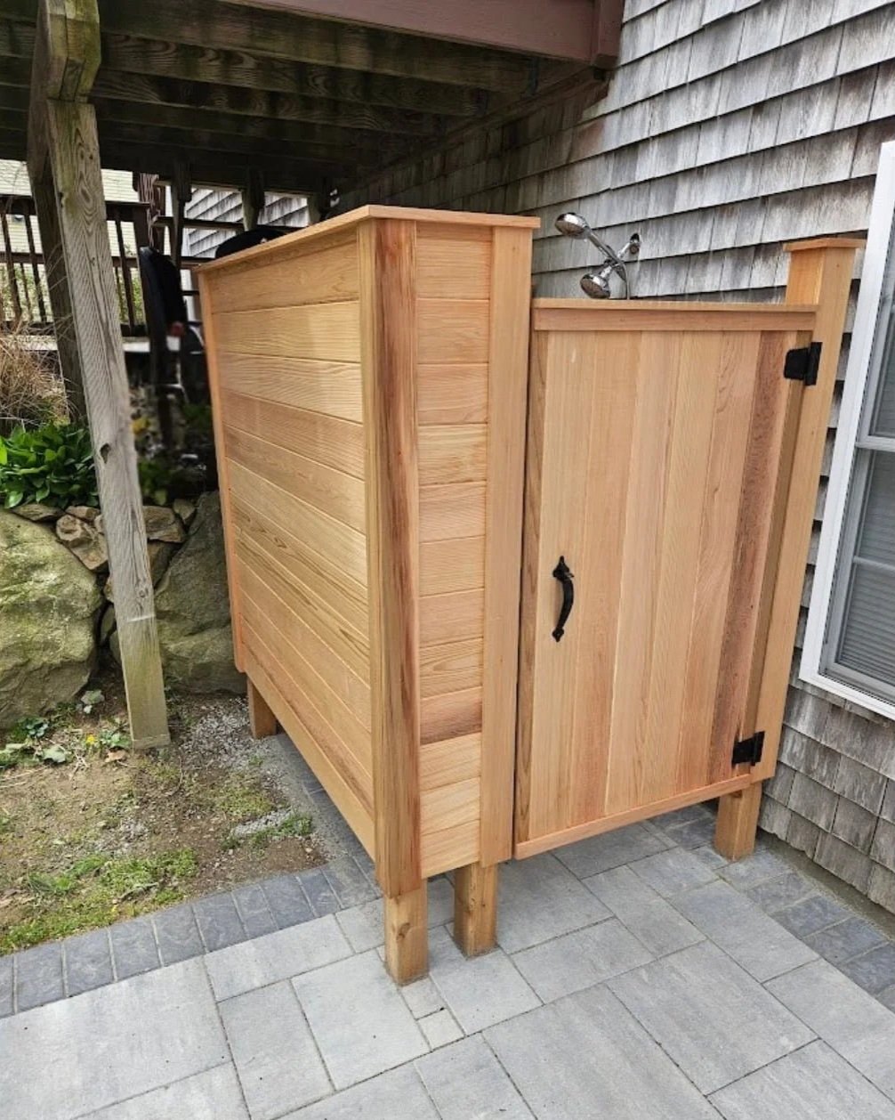 Custom cedar outdoor shower with warm natural wood tones, slatted privacy enclosure, and handcrafted carpentry details. Rhode Island outdoor showers are the best.