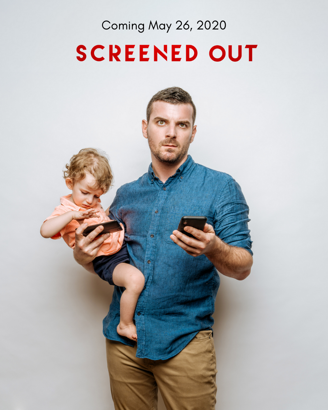A man holding a young child in his arm, both looking at their smartphones with confused or worried expressions, standing in front of a plain background with text indicating a movie release date and title.
