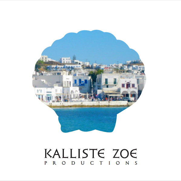 A coastal scene with white buildings along the shoreline, under a bright blue sky, with water in the foreground.