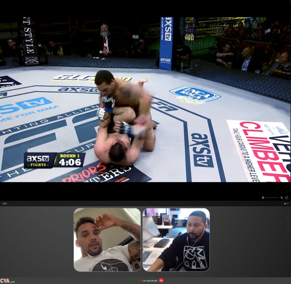Mixed martial arts fight in a cage with two fighters, one on top of the other, surrounded by referees and spectators, with a video call window of two men at the bottom.