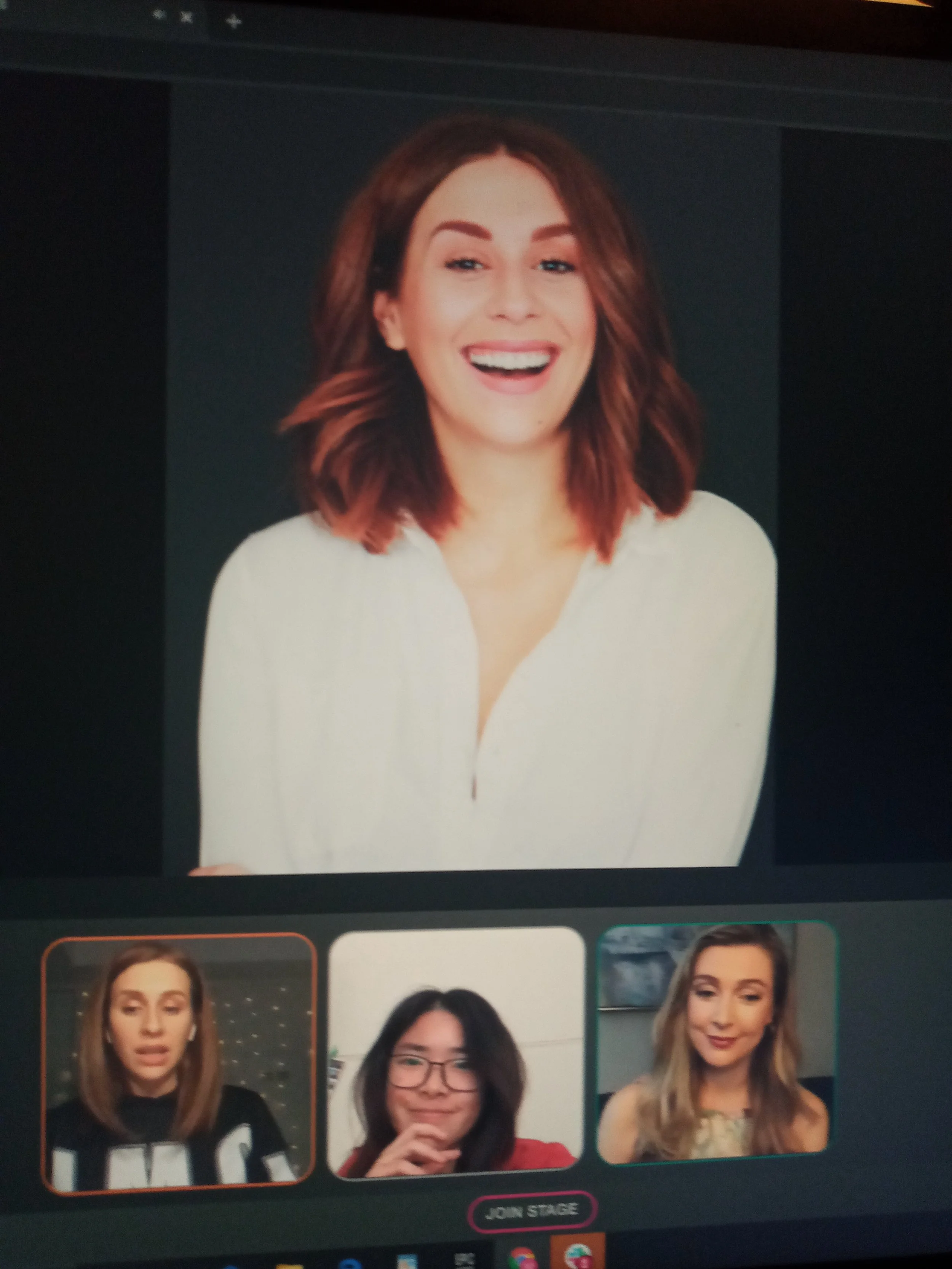 A woman with shoulder-length red hair, wearing a white shirt, smiling at the camera, with three smaller images of different women below showing various facial expressions and hairstyles.