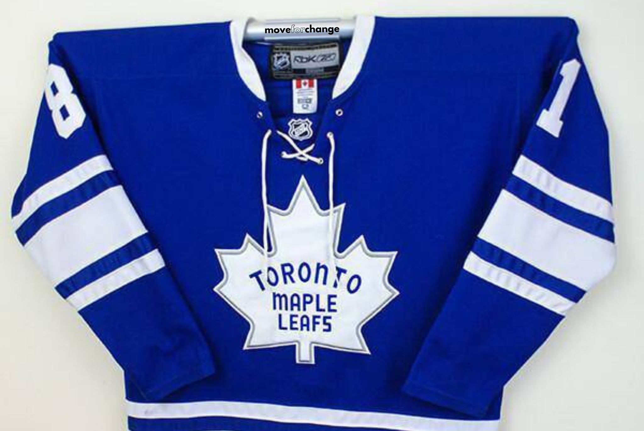 Toronto Maple Leafs hockey jersey in blue with white logo and stripes.
