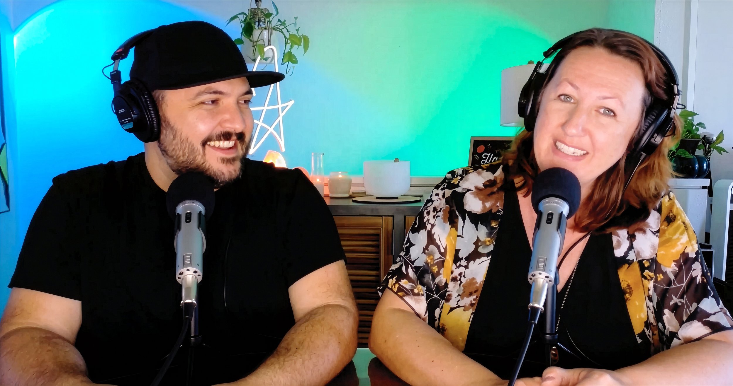 Frank and Lauren speaking into microphones during a Clairvoyaging podcast recording about intuition, parenting, and unusual experiences.