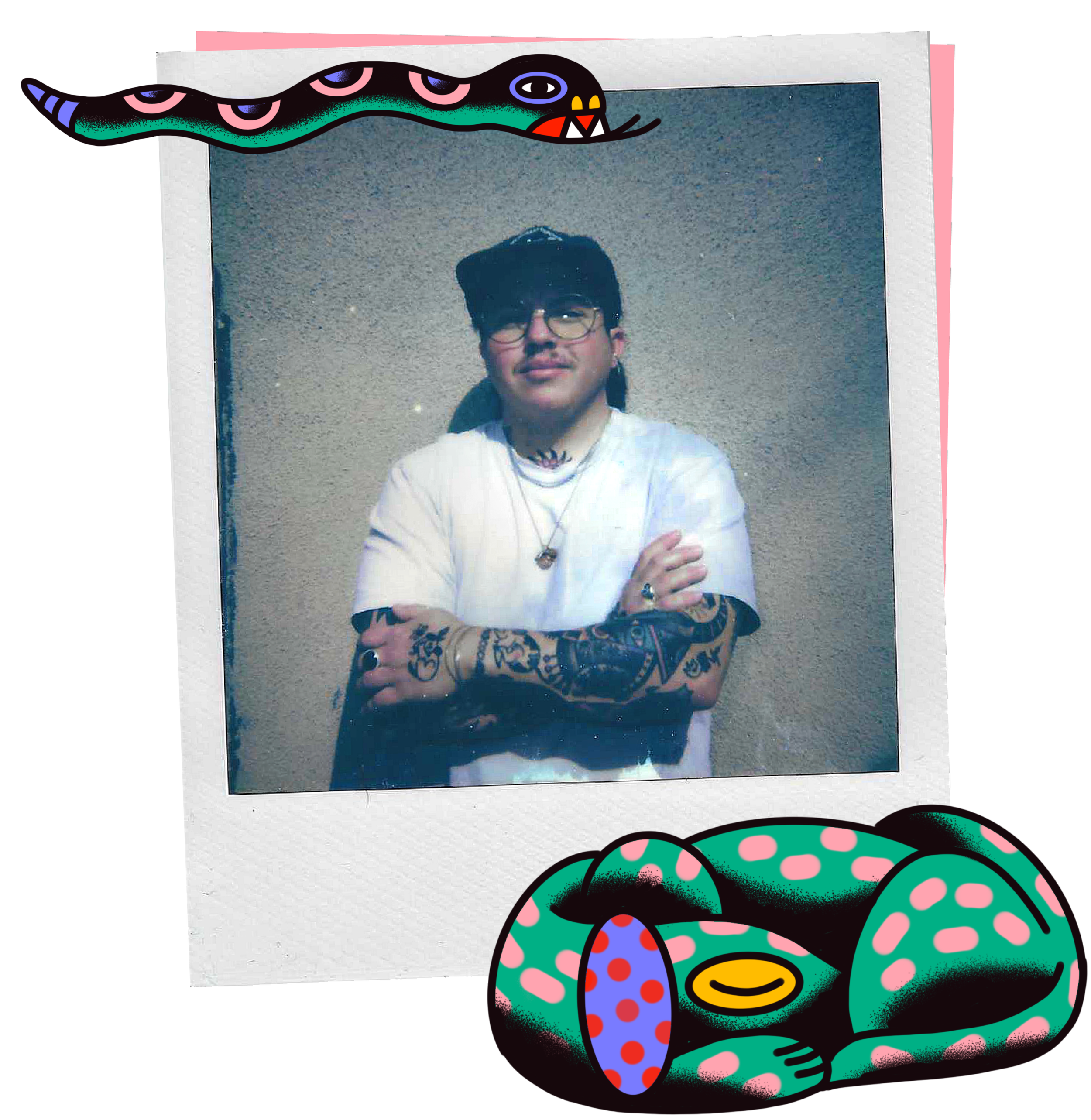 Kori Callu, a queer, trans Mexican-American man with dark hair, glasses, and tattoos on his arms, standing against a textured wall, wearing a white t-shirt, necklaces, and a ring, with his arms crossed.