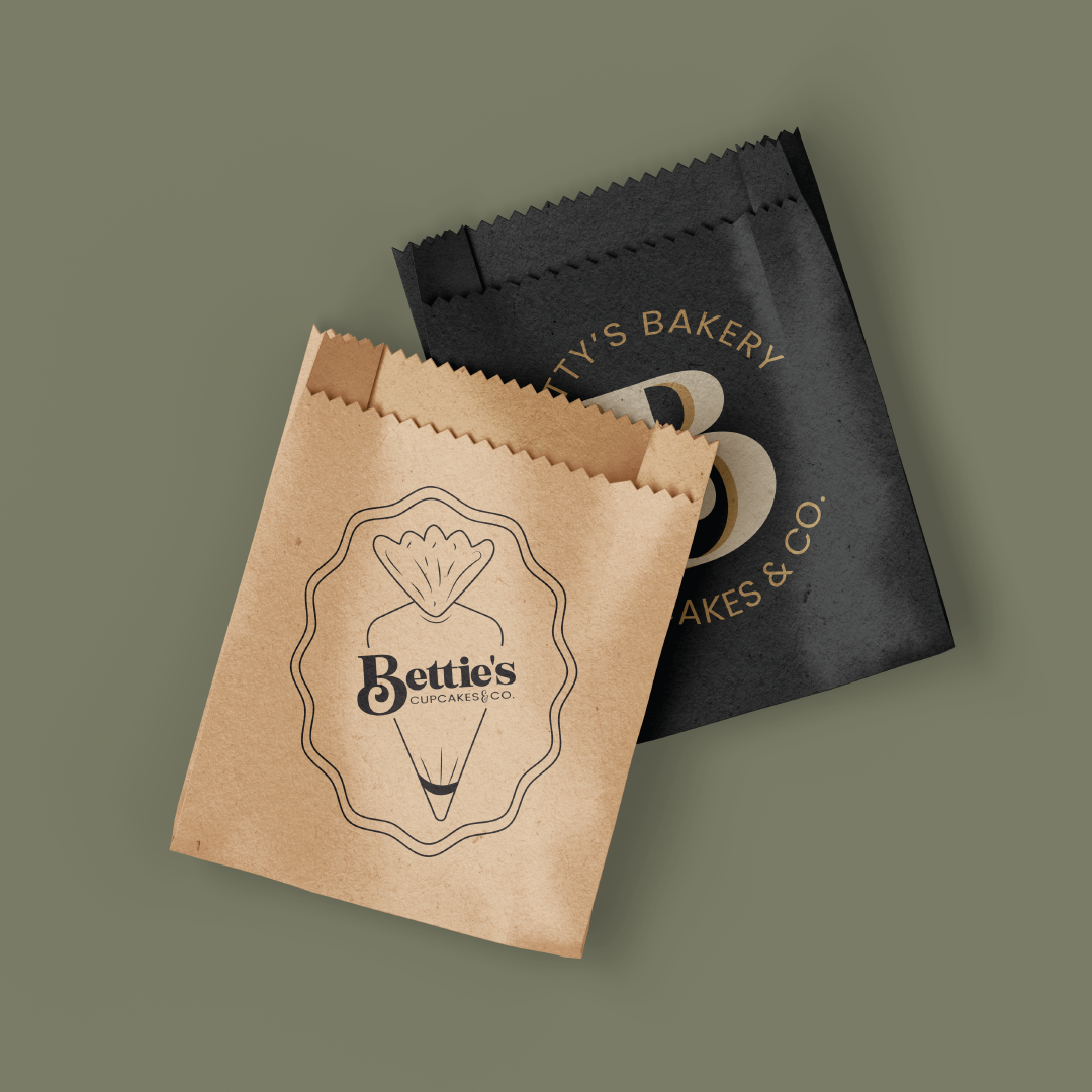 Two bakery paper bags with logos, one black, one brown.