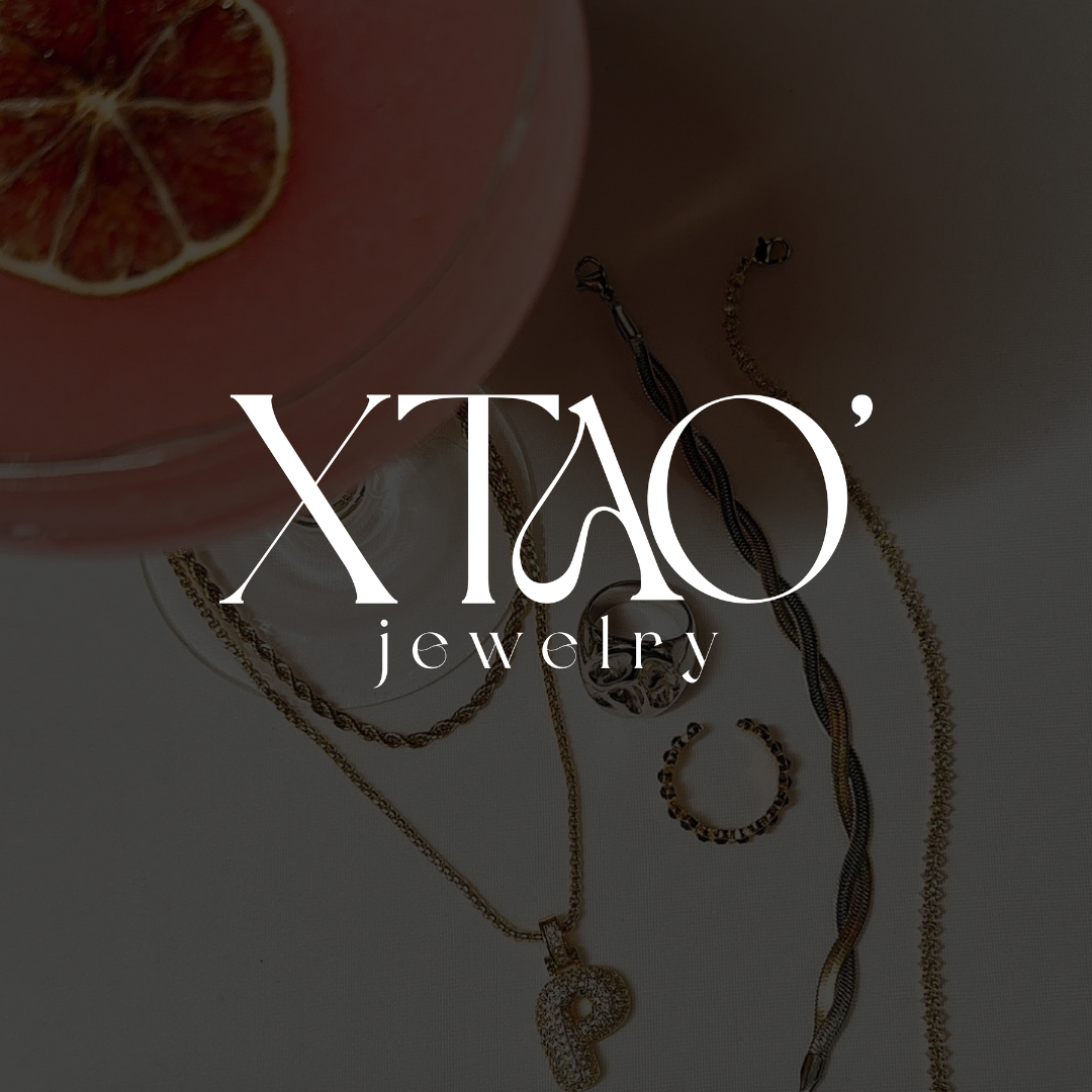 Jewelry pieces including chains and rings with a grapefruit cocktail. Text overlay reads 'XTAO' jewelry.'