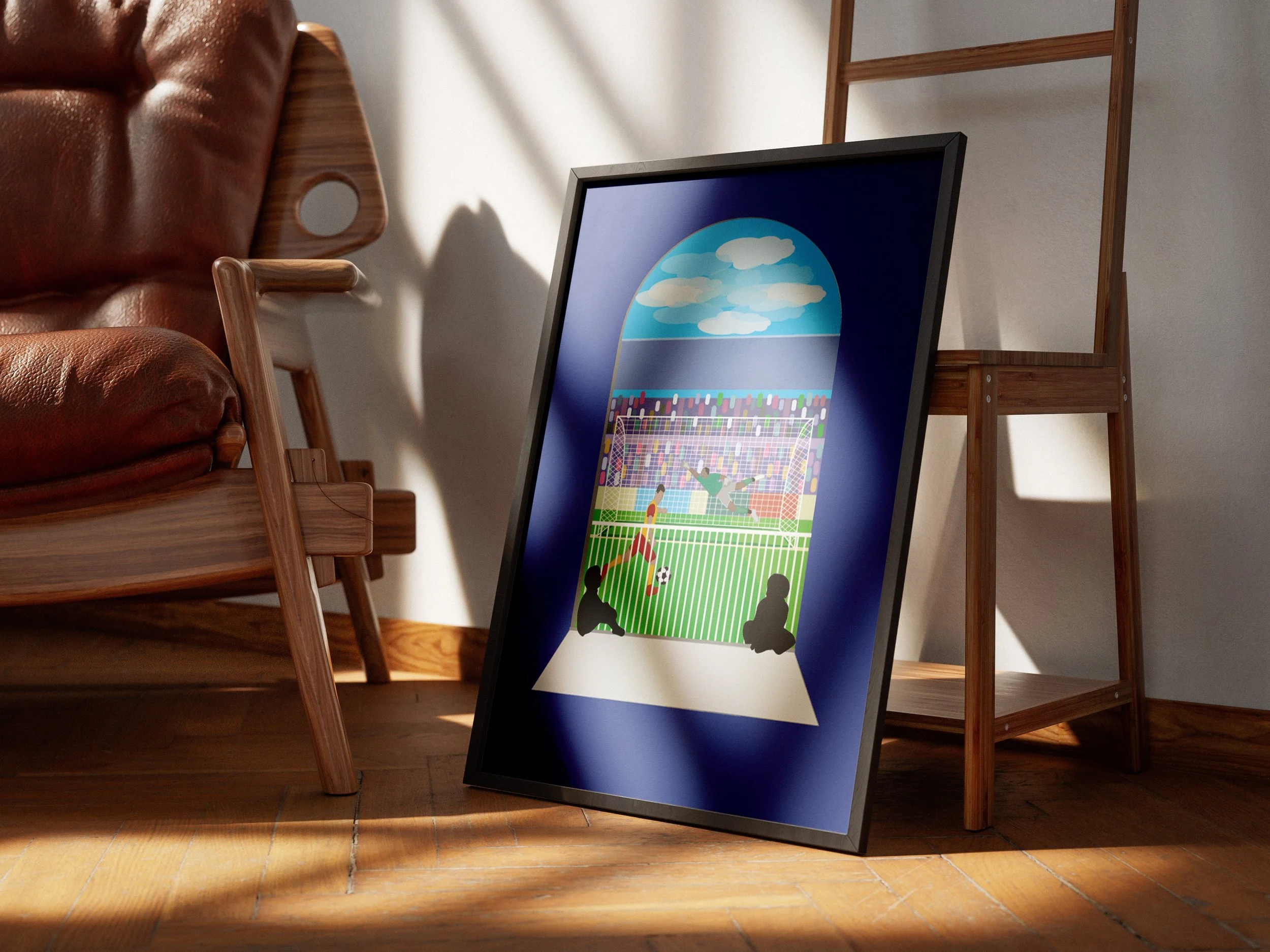 Framed art print of children playing soccer on a field with a goal, viewed through an open door, with sunlight and shadows on the wooden floor, in a room with chairs and a ladder.