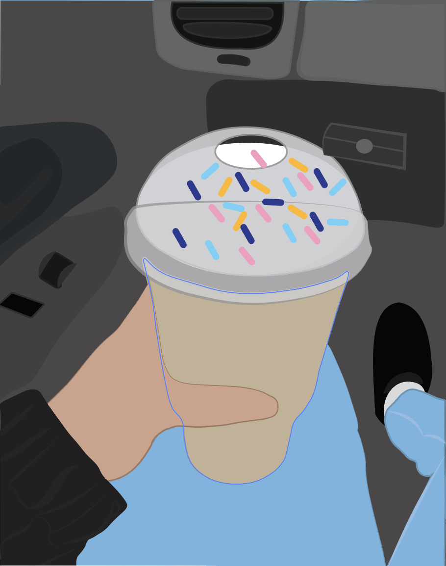 Person holding a large donut in a car, decorated with colorful sprinkles on top.