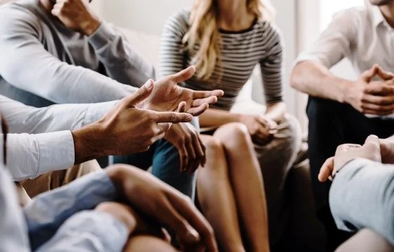 Group of people sitting in a circle having a discussion