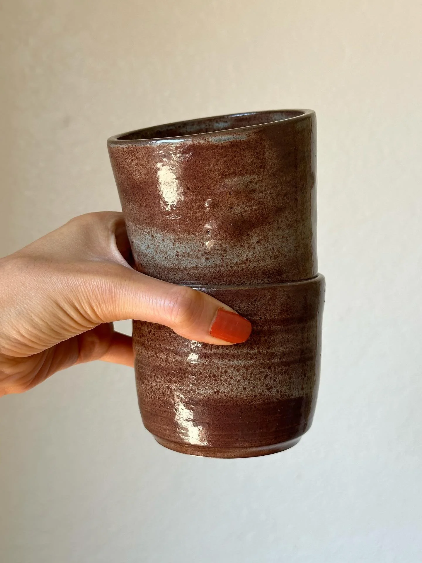 light blue shino on dark brown clay 
 3.5&rdquo; X 3&rdquo;
holds ~ 8 oz 
$30 each or $50 for the set 
 #ceramics #cups #swirl #socal #pottery #handmade #wheelthrown #glazed #clay #shopsmall #ceramiccup #lightblueshino