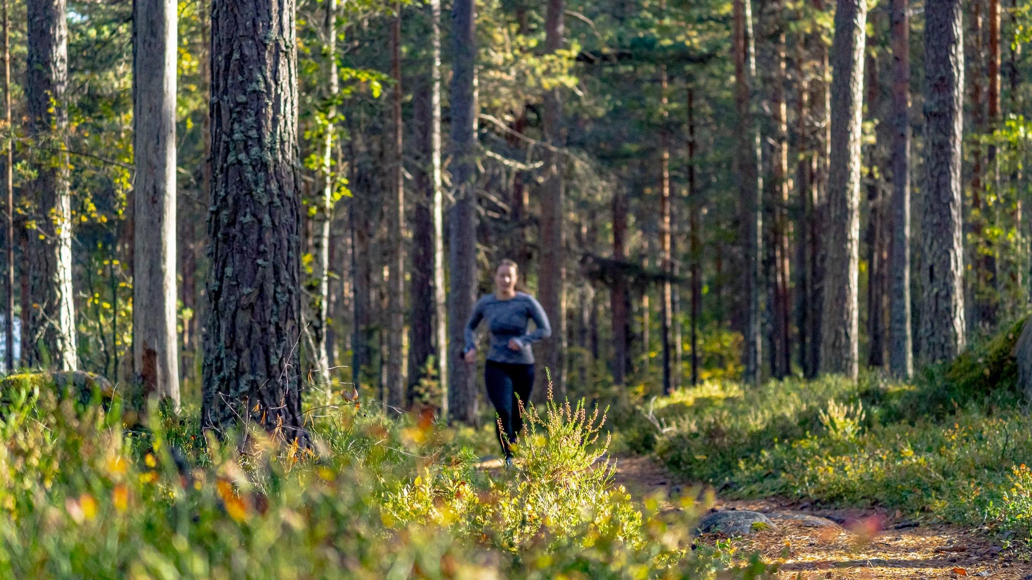 Rachel Collins High Performance Psychology Coach for Athletes running outside in the woods.