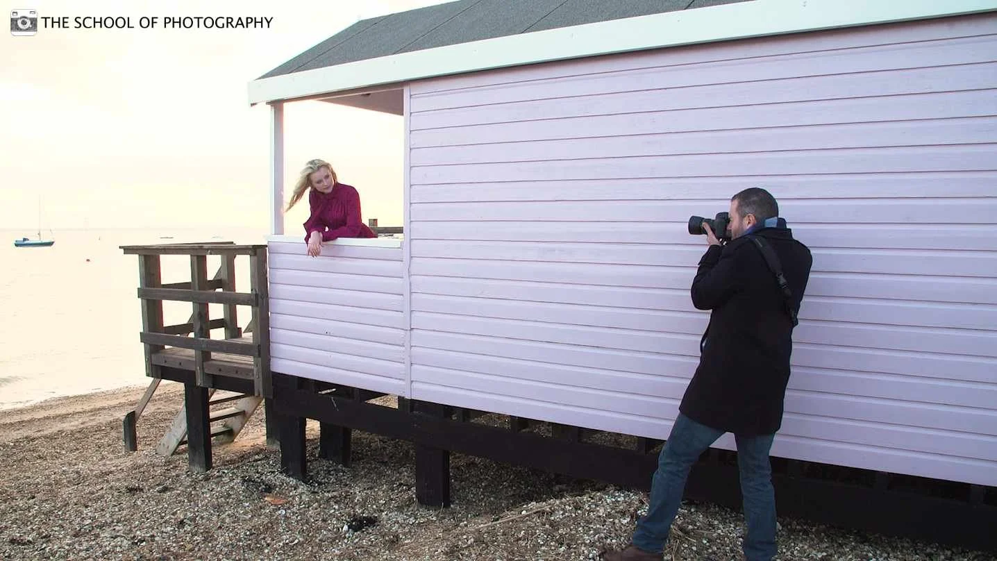 Behind the scenes of a portrait photography shoot at a beach hut
