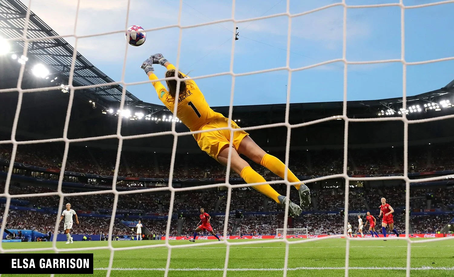 USWNT goalkeeper Alyssa Naeher makes a crucial diving save during the 2019 Women's World Cup semifinal against England. This dynamic action shot, captured by famous sports photographer Elsa Garrison