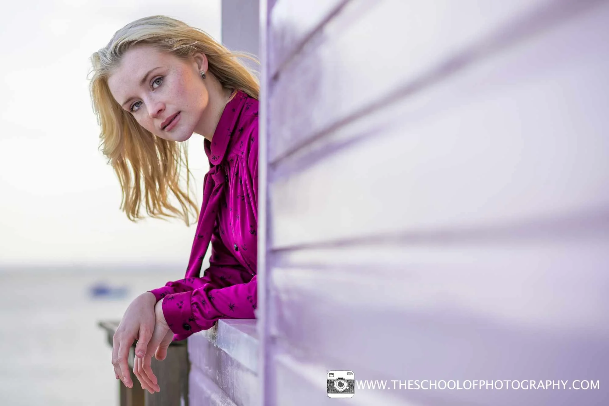 Portrait photography using leading lines of a beach hut to draw attention to the model