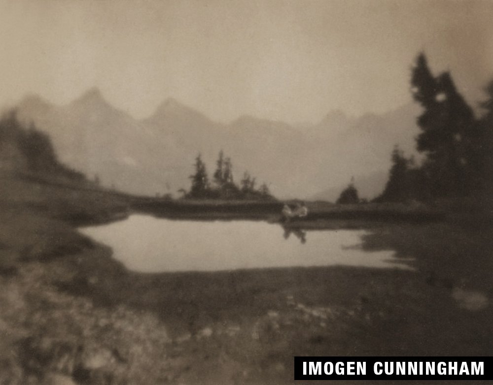 Black and white photograph of mountains, lake, and trees by Imogen Cunningham.