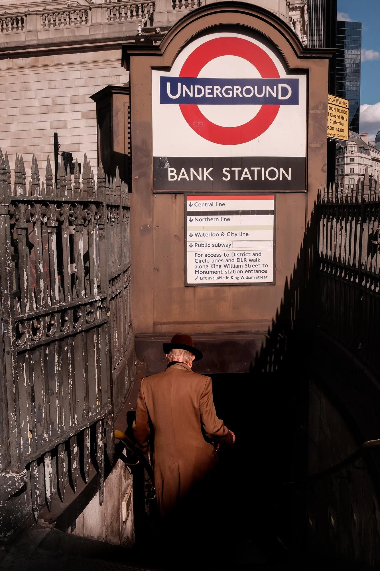 Man walking down the stairs at Bank Underground station in London street photography scene