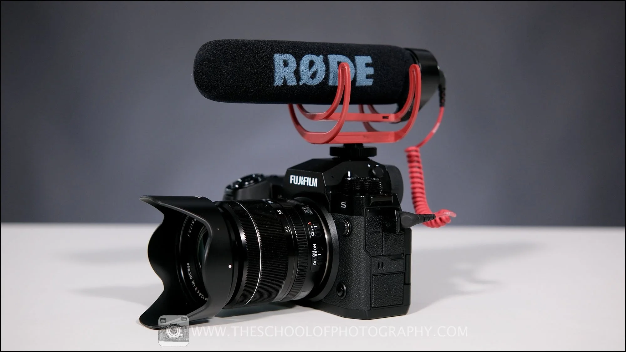 Camera fitted with a shotgun microphone mounted on top, used to capture directional audio for video recording.