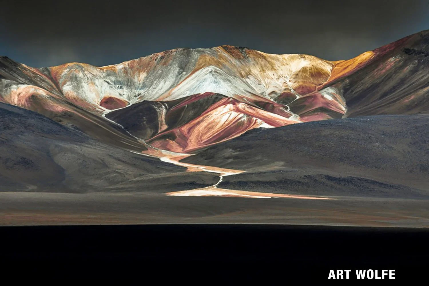Vivid, colourful mountains with a flowing river.
