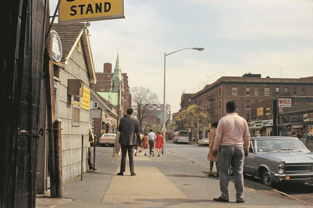 street in queens new york with people walking on the street in the 70s
