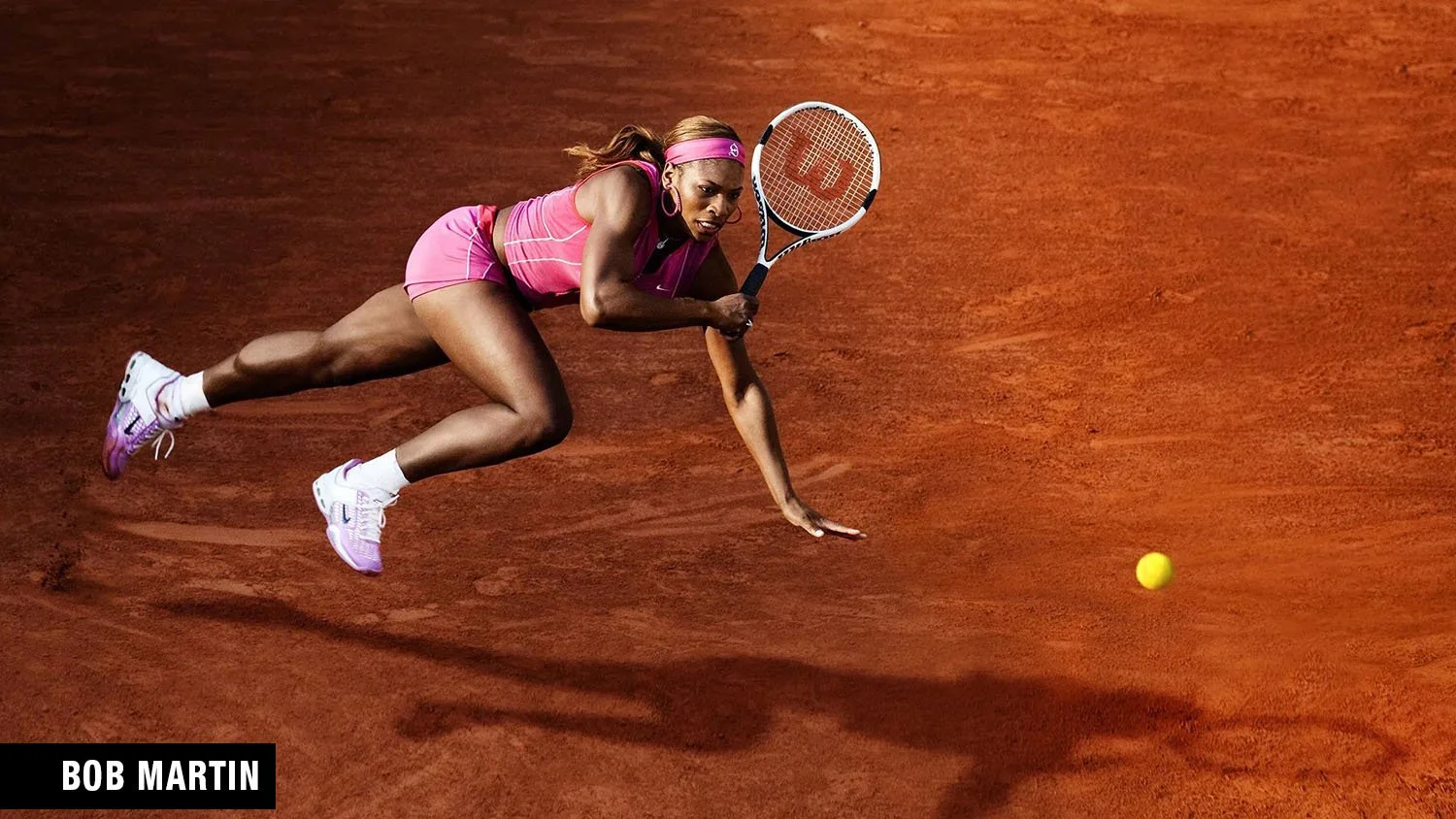 Serena Williams lunging for a return during the 2004 French Open at Roland Garros, captured by world-renowned photographer Bob Martin