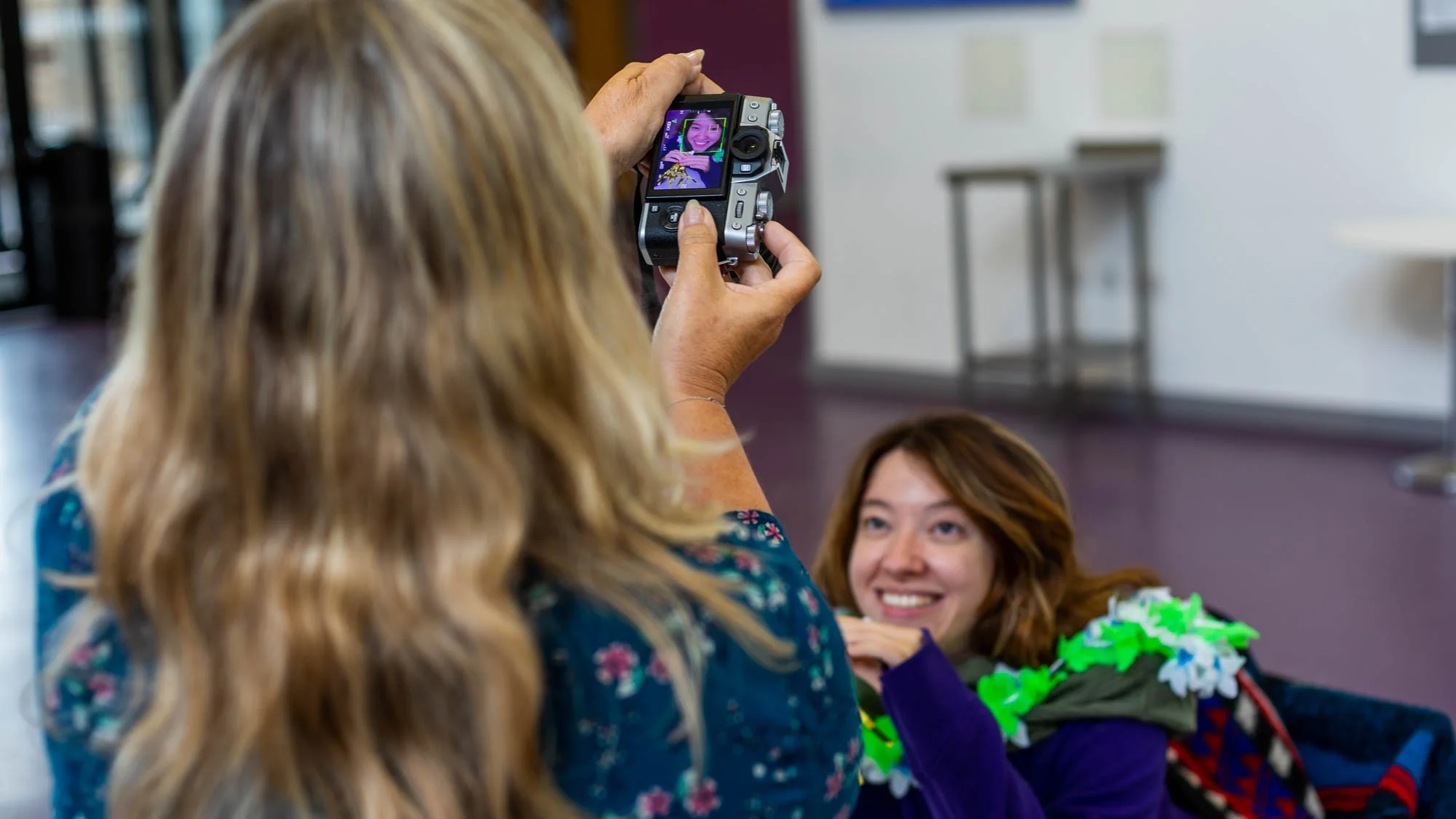 Photography student practising composition and creativity while taking a portrait during a photography class.