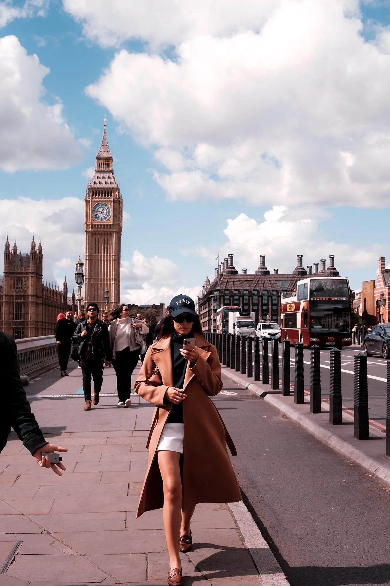 Woman walking across Westminster Bridge with Big Ben in the background in London street photography
