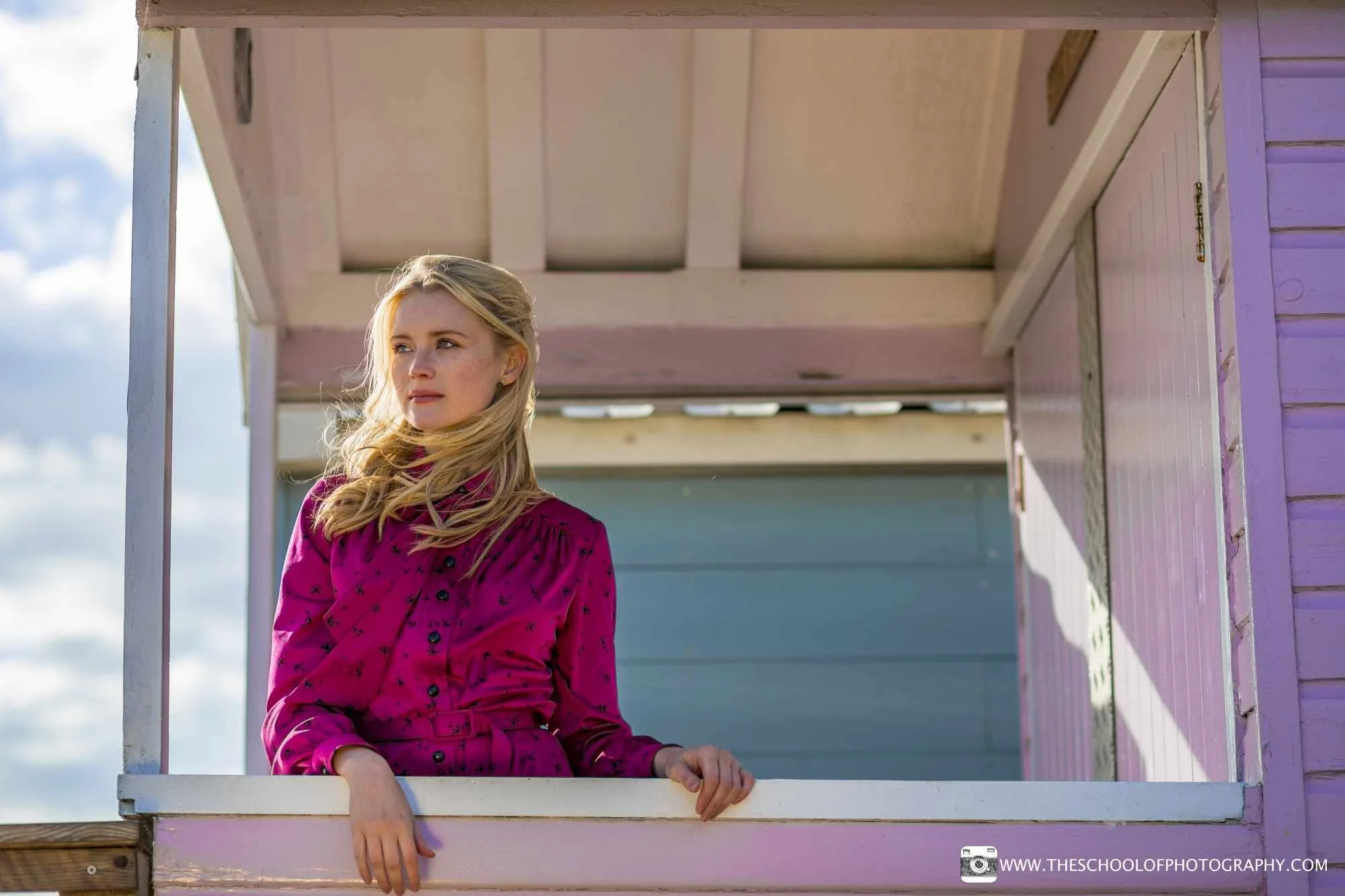 Behind the scenes of a portrait photography shoot at a beach hut