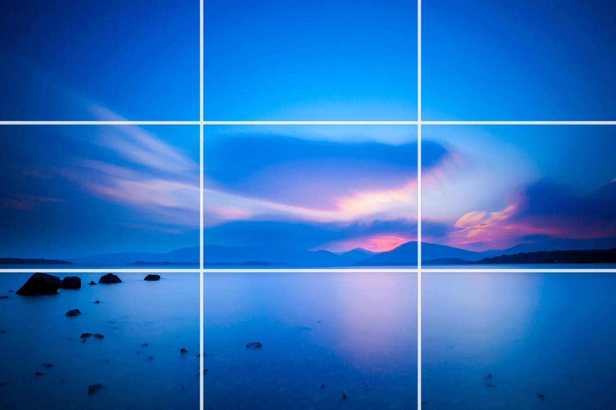 Landscape sunset with a rule of thirds grid overlay demonstrating photography composition.