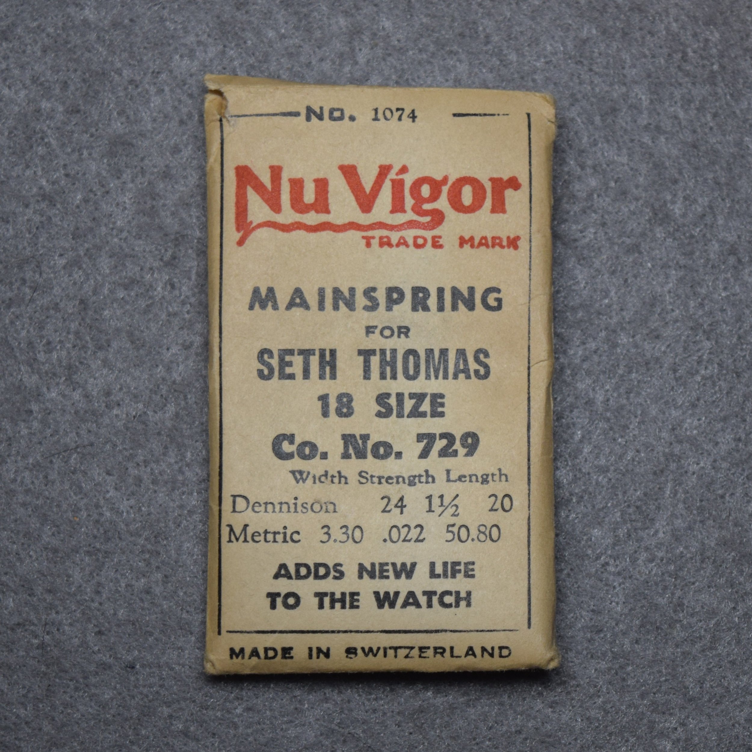 Nu Vigor Mainspring Package No. 1074 – for Seth Thomas 18-size Factory No. 729 – 50.80 centimeters long, 3.30 wide, .022 thick, or, 24 wide, 1½ thick, 20 inches long Dennison gauge - Made in Switzerland