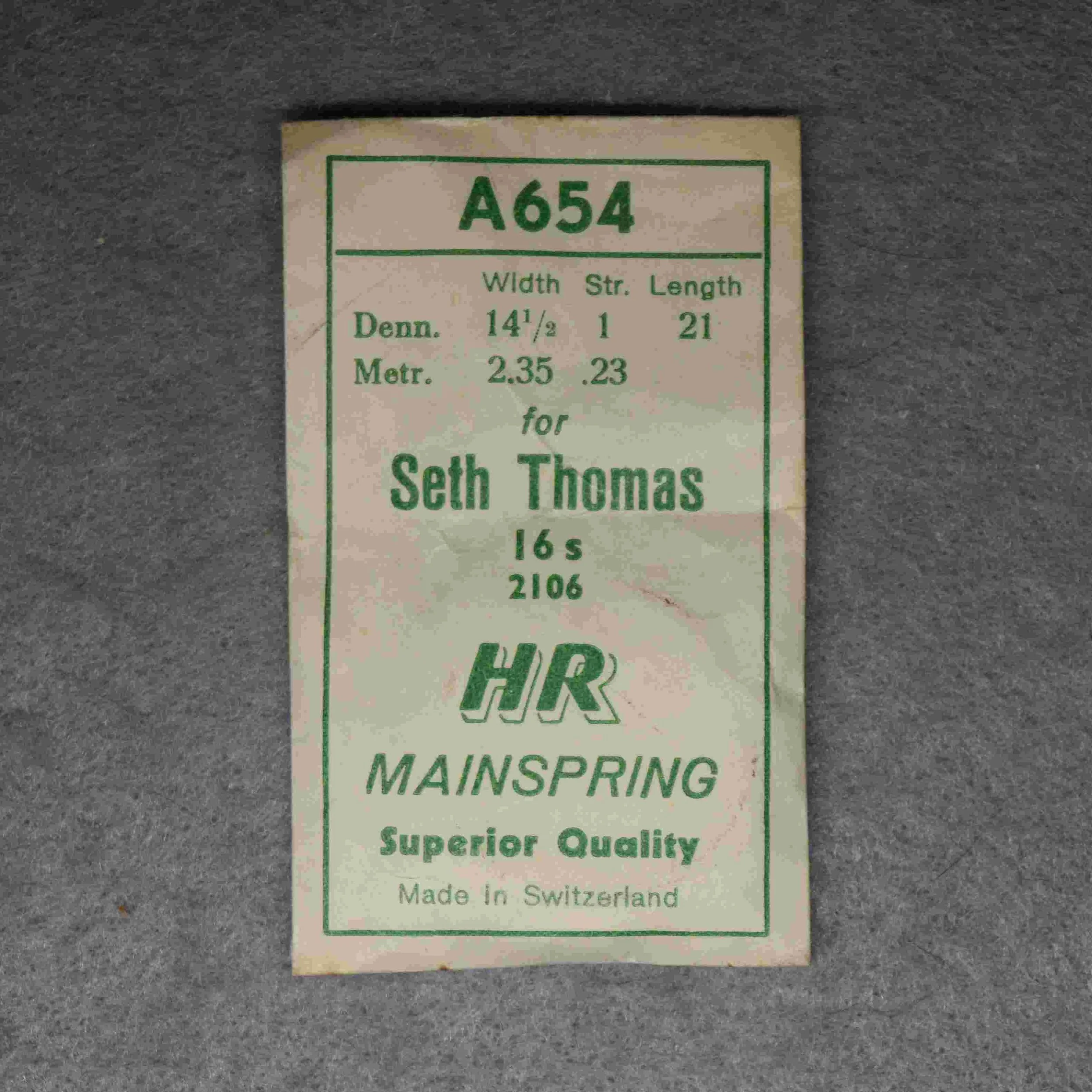 HR Alloy Mainspring Package No. A 654 – for Seth Thomas 16-size Factory No. 2106, 21 inches long, 2.35 millimeters wide, 0.23 thick, or, 14½ wide, 1 thick Dennison gauge - Made in Switzerland