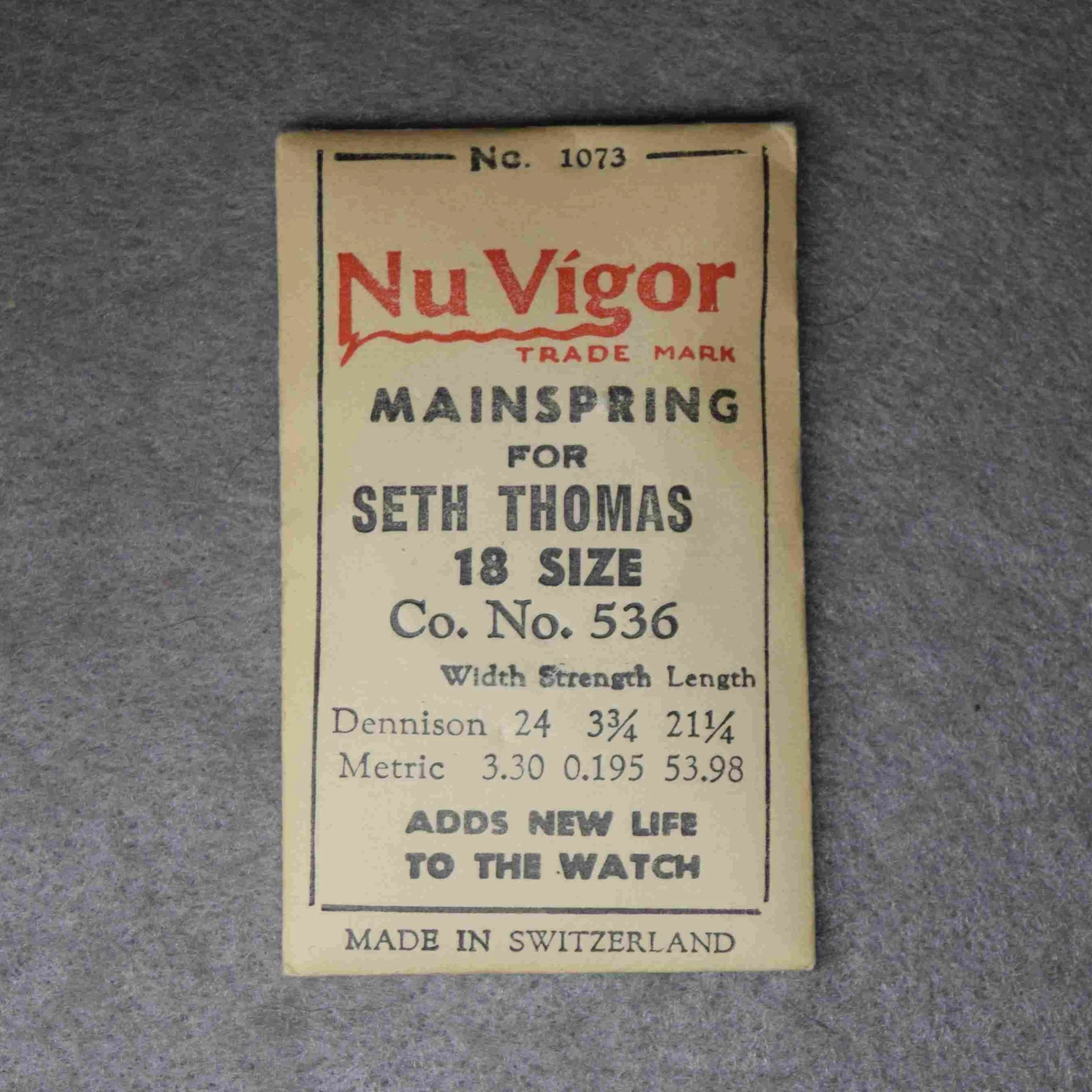Nu Vigor Mainspring Package No. 1073 – for Seth Thomas 18-size Factory No. 536 – 53.98 centimeters long, 3.30 wide, .195 thick, or, 24 wide, 3¾ thick, 21¼ inches long Dennison gauge - Made in Switzerland