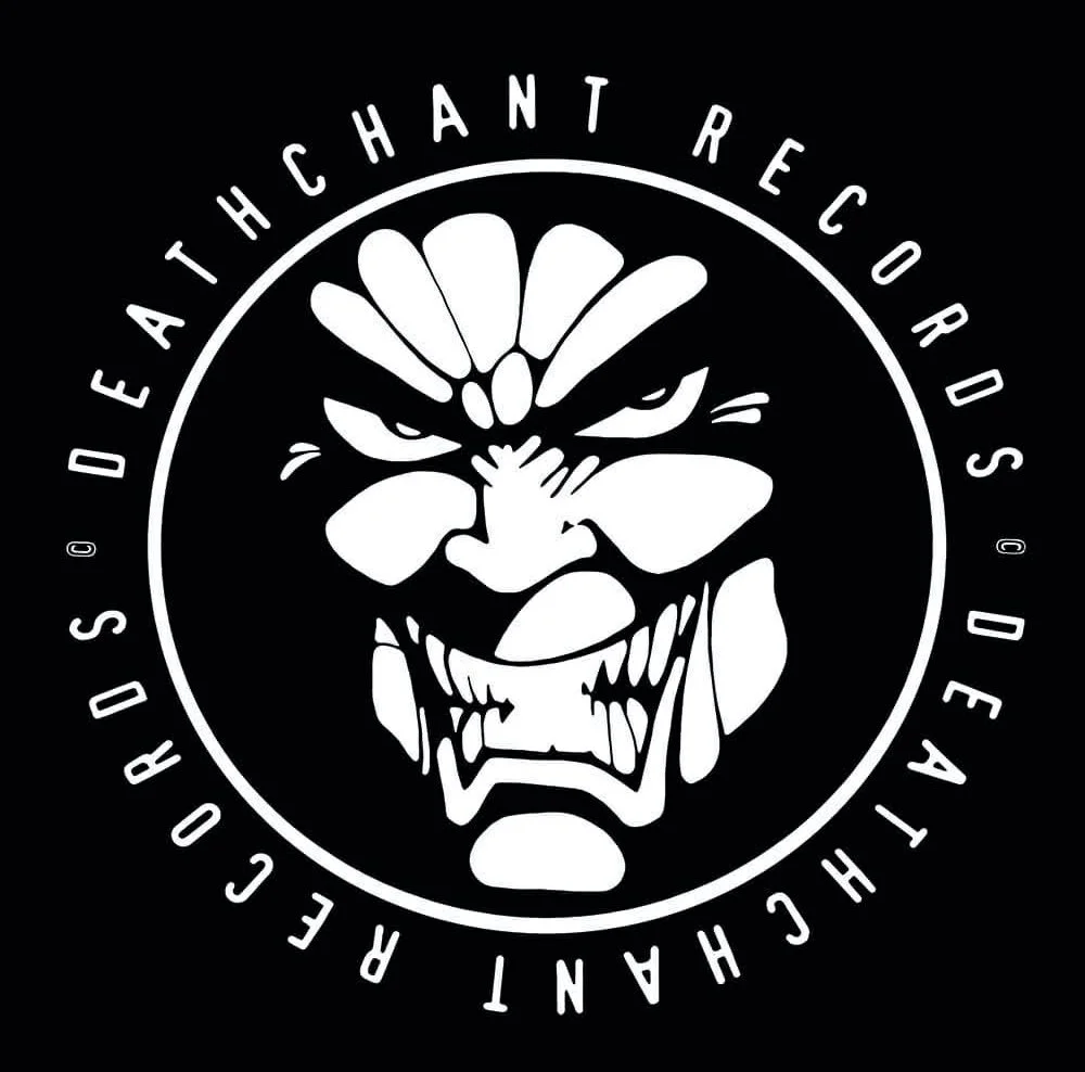 A circular logo with a stylized, fierce face resembling a tiki or tribal mask in black and white, surrounded by the text 'DEATHCHANT RECORDS' and 'RECORDS' in a circular pattern.