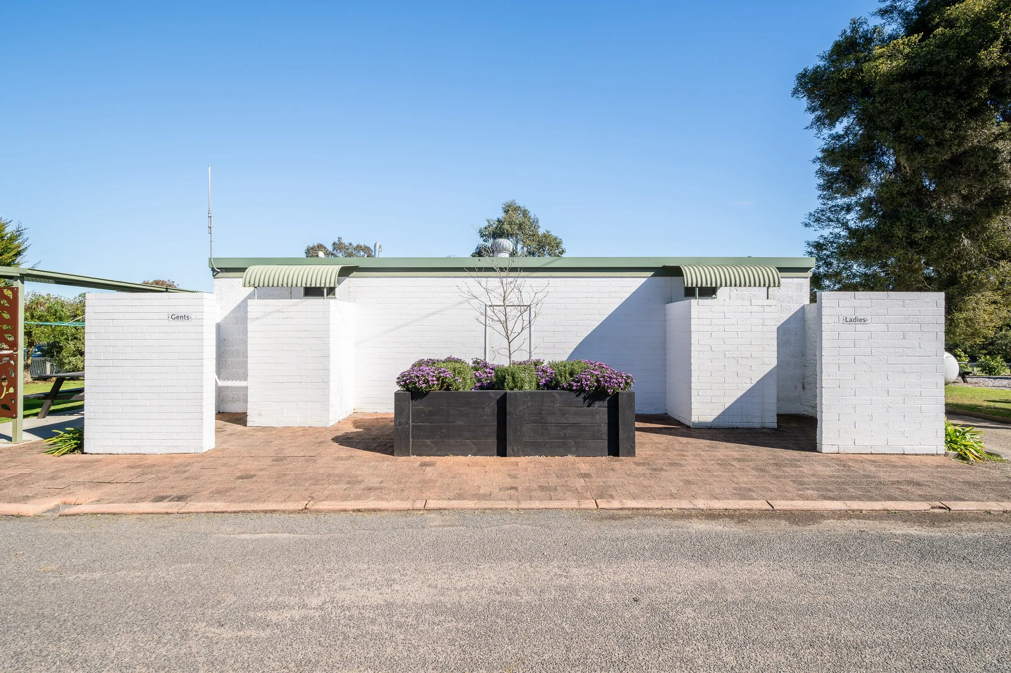 Modern holiday park amenities building and landscaped entrance - Caravan Park photography