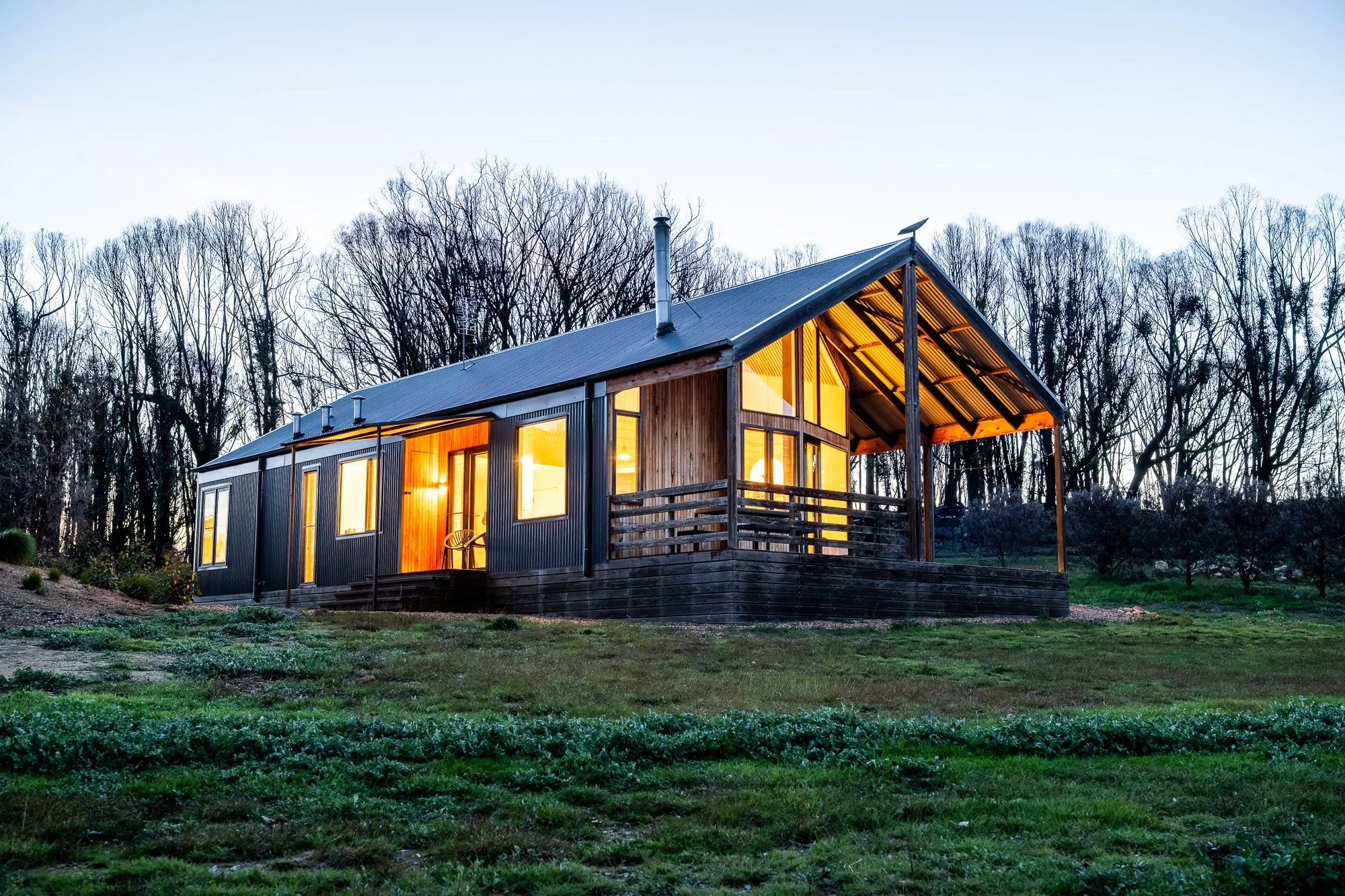 Country accommodation cabin at dusk surrounded by rural landscape in Victoria