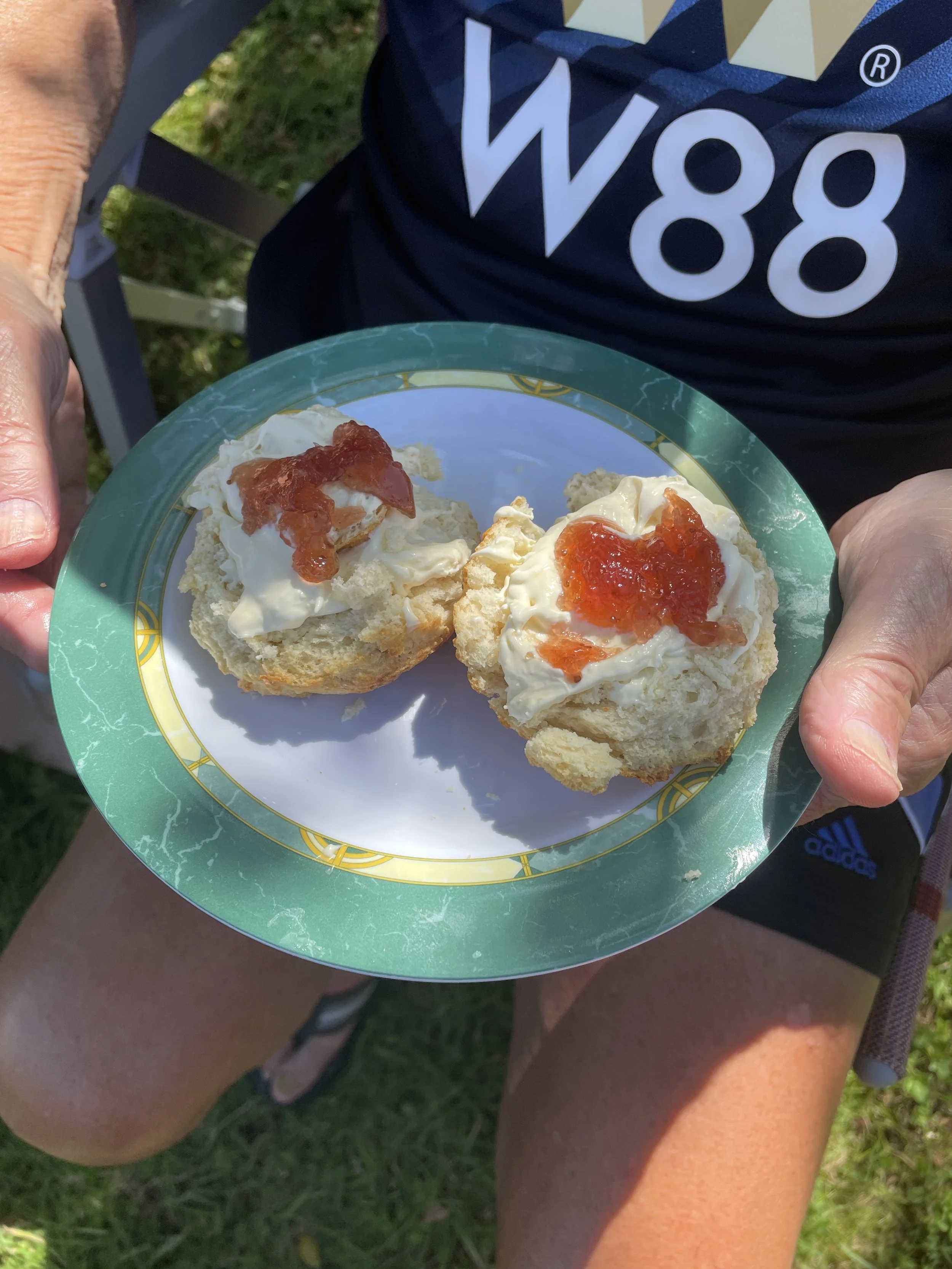 Others prefer the jam on top of the cream.