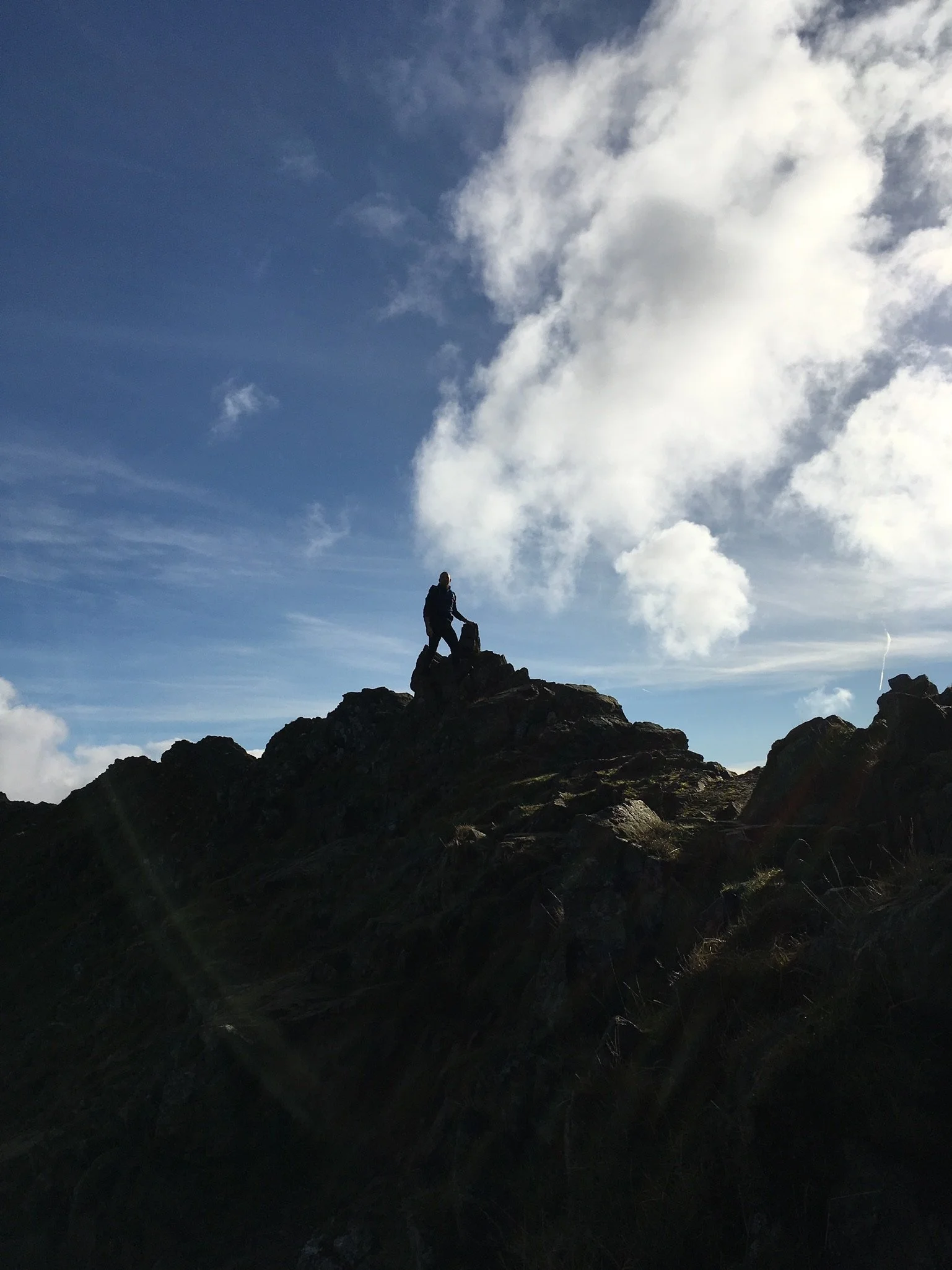 Silhouette of a man mountain running