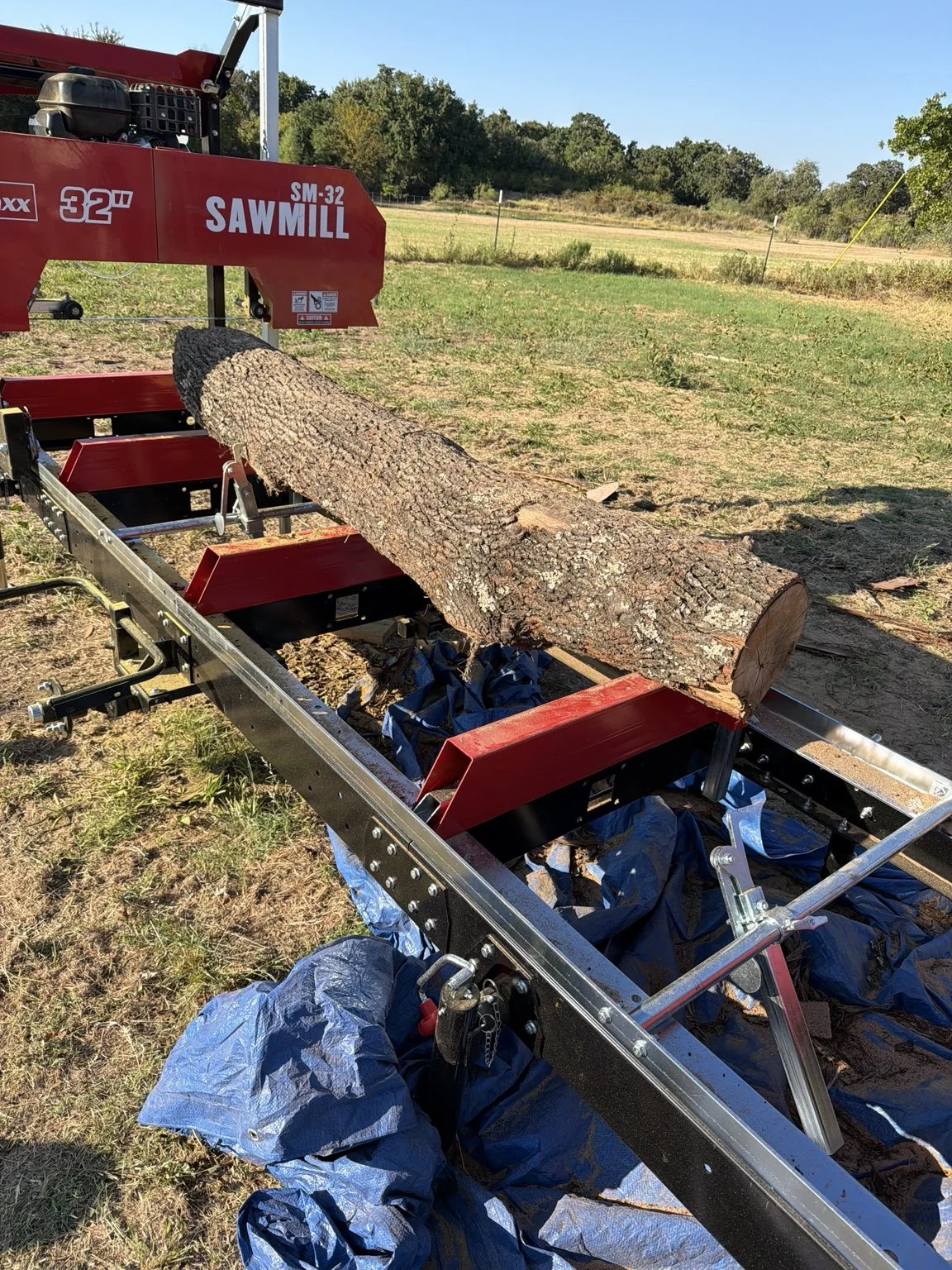 Long hardwood log positioned on the MechMaxx SM-32 sawmill bed