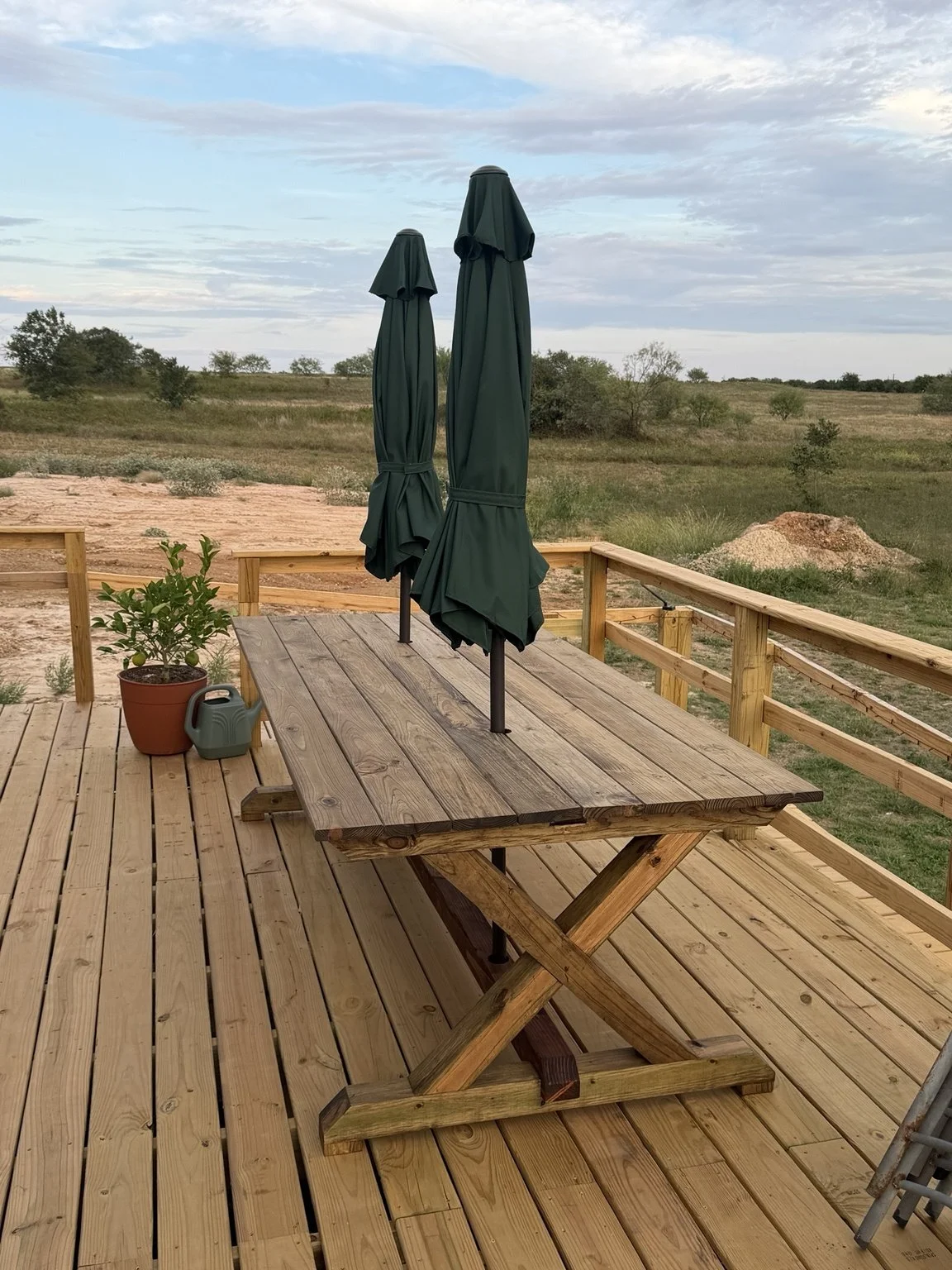 Completed Liberty Woodworks outdoor X-frame dining table on a deck
