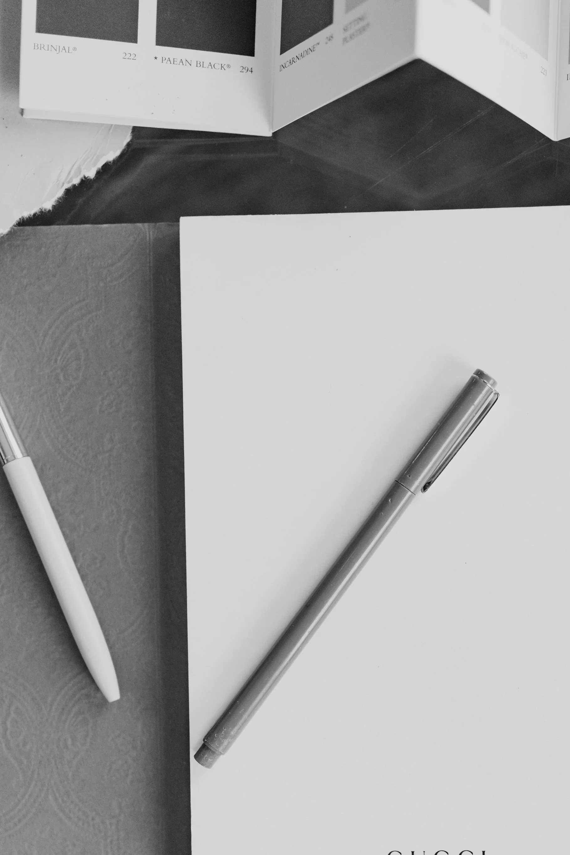 pen on Gucci notepad in black and white