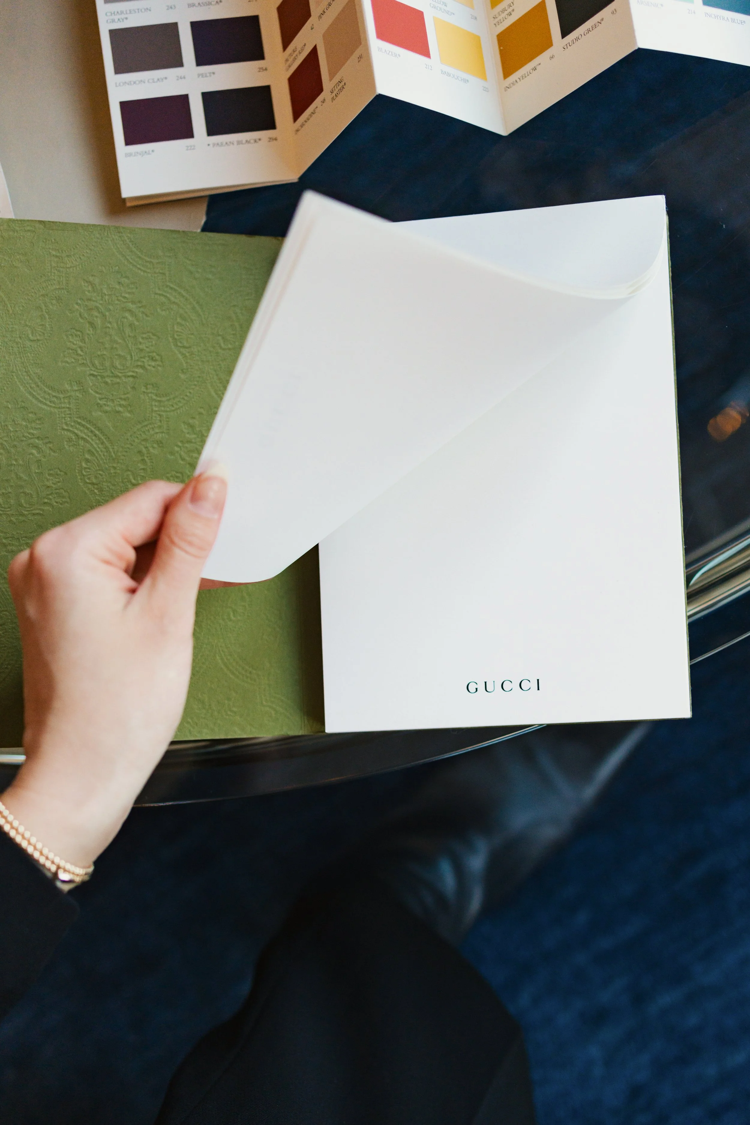 Green Gucci notebook being flipped through