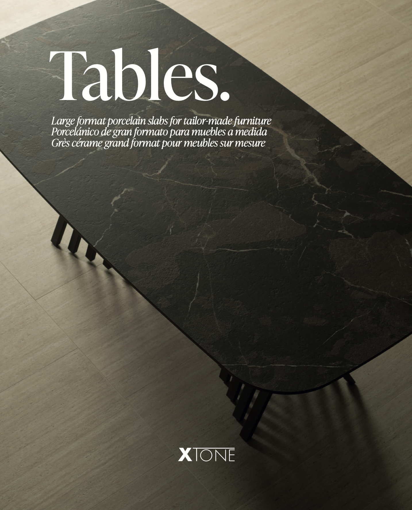 A black porcelain slab with white veining, featuring text promoting custom furniture tables, placed on a light-colored wooden floor.