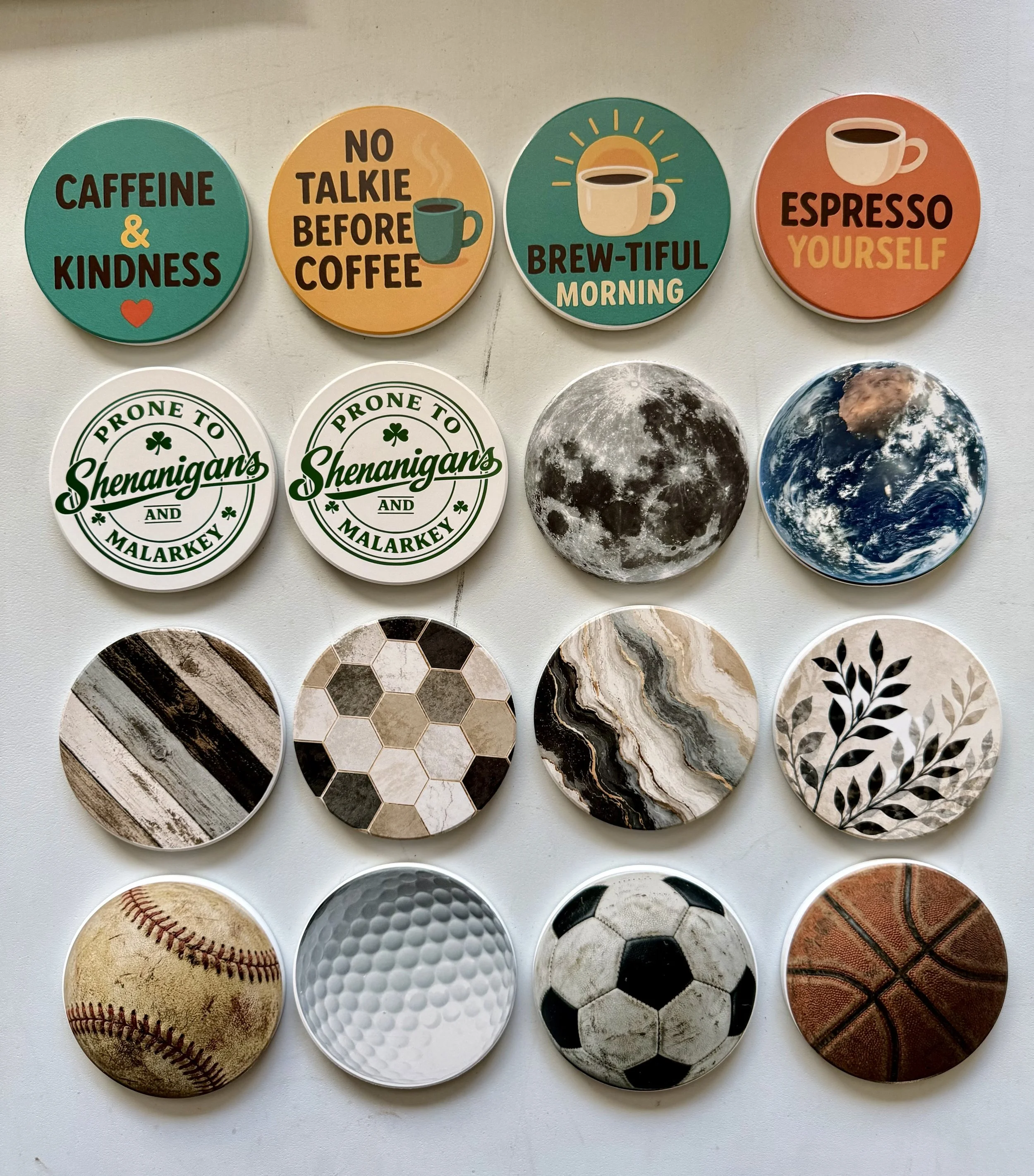 Collection of 12 circular stickers with various designs, including coffee, moon, earth, baseball, golf ball, soccer ball, basketball, and patterns.