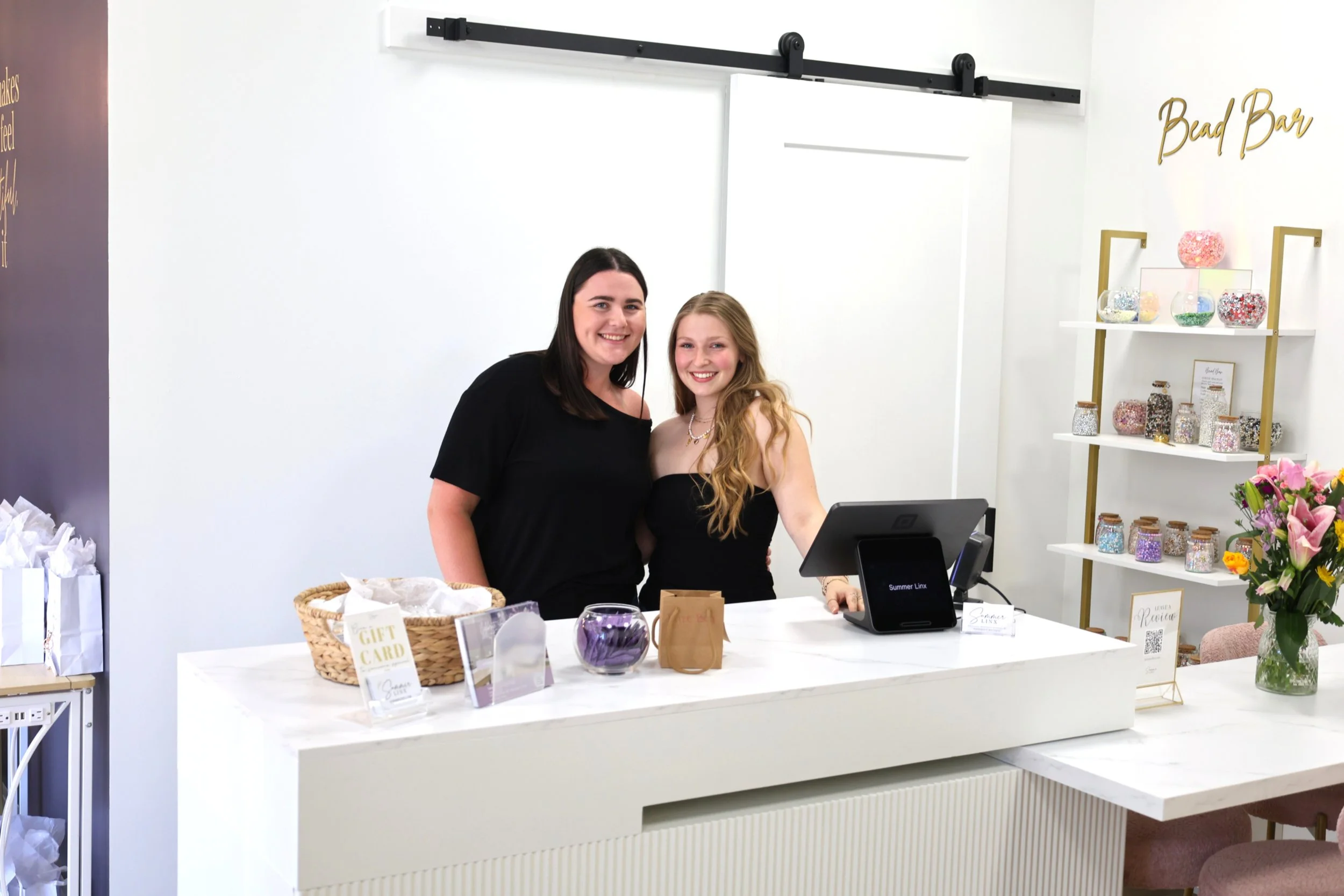 2 girls standing at bar in summer linx